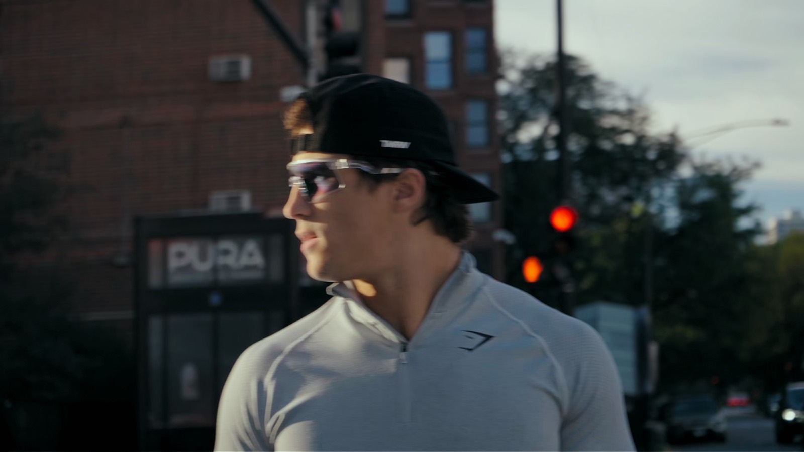Logan in a backwards cap and Spekoptics sunglasses on a city street